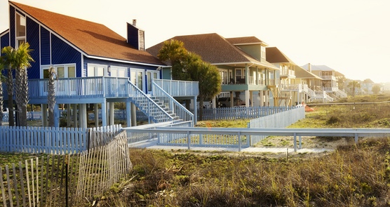 houses along beach with impact hurricane coastal windows